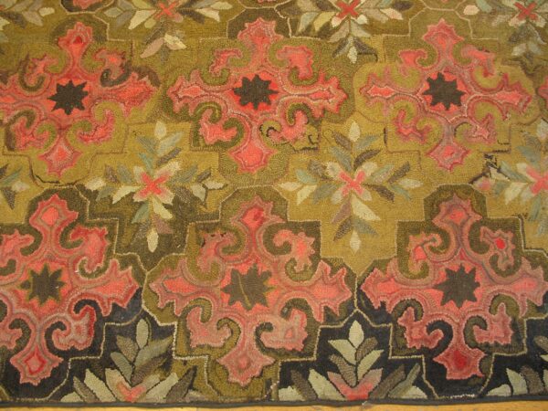 Close-up of a hooked rug featuring olive green and coral paisley motifs with dark accents by rugs on net. By rugs on net