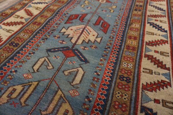 Close-up of a blue field rug with geometric patterns and borders by rugs on net