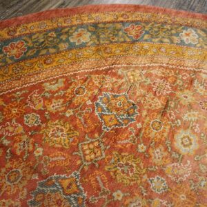 Close-up of the border details on the distressed orange floral rug by Rugs On Net