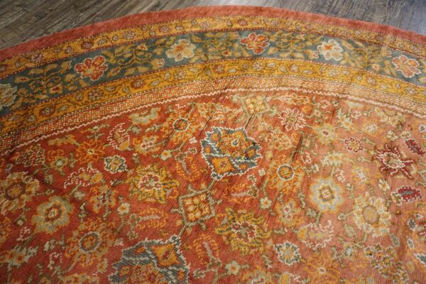 Close-up of the border details on the distressed orange floral rug by rugs on net