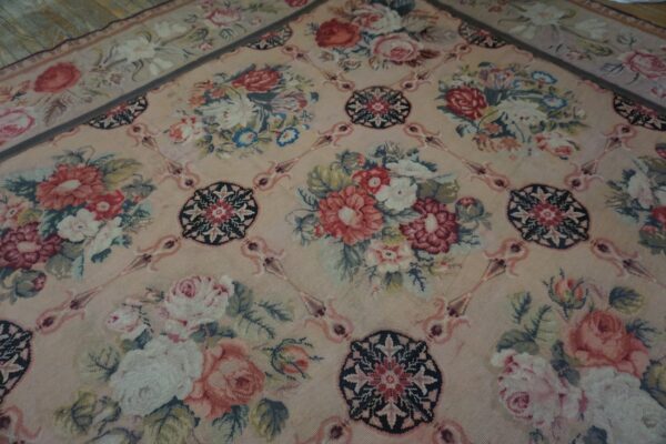 Close-up of a pink aubusson-style rug with large floral bouquets and medallions by rugs on net