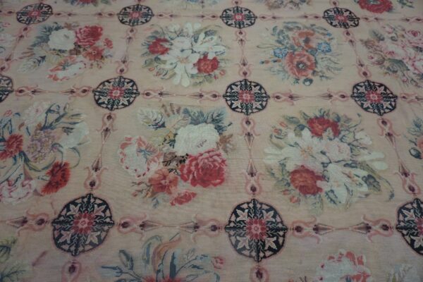 Close-up of a floral tapestry rug with a beige background and bouquets of red and white roses by rugs on net. By rugs on net