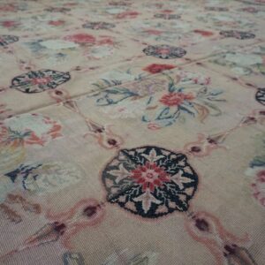 Close-up of a light pink floral needlepoint rug with repeating medallions by Rugs On Net. by Rugs On Net