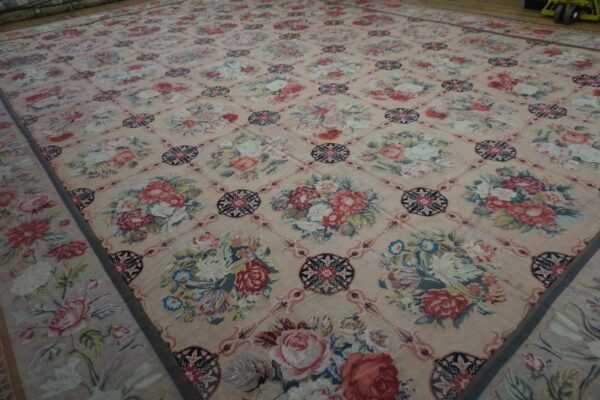 Close-up of a large floral tapestry rug with pink and cream tones by rugs on net
