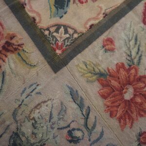 Close-up of a floral needlepoint rug pattern featuring red and pink roses by Rugs On Net. by Rugs On Net
