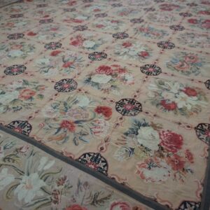 Close-up of a pink needlepoint rug with large floral bouquets in a lattice pattern, by Rugs On Net
