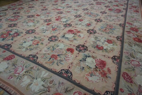 Close-up of a pink needlepoint rug with large floral bouquets in a lattice pattern, by rugs on net