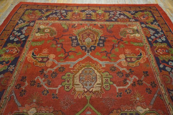 Close-up of a richly detailed red rug with intricate geometric and floral patterns, by rugs on net. By rugs on net