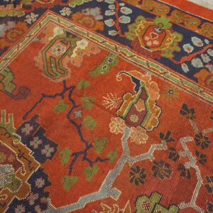 Close-up of a richly colored red rug with dark blue and green accents, featuring geometric and floral motifs of the 'Antique Persian Serapi' design by Rugs On Net. by Rugs On Net