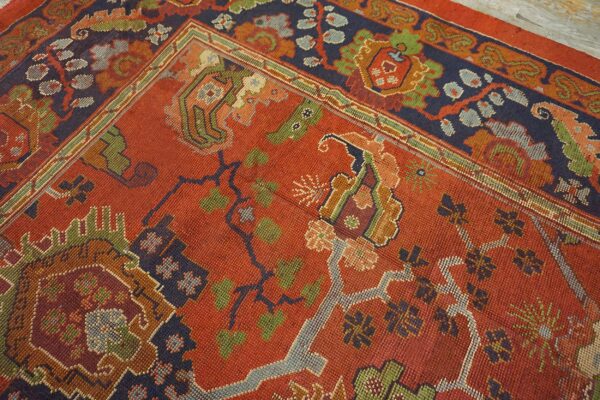 Close-up of a richly colored red rug with dark blue and green accents, featuring geometric and floral motifs of the 'antique persian serapi' design by rugs on net. By rugs on net