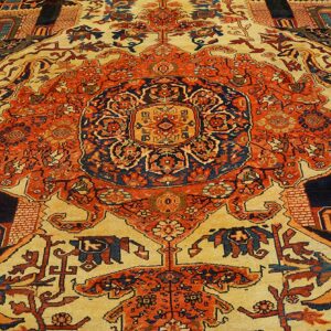 Close-up of a richly patterned rug featuring central medallions and architectural motifs in orange, blue, and cream, by Rugs On Net