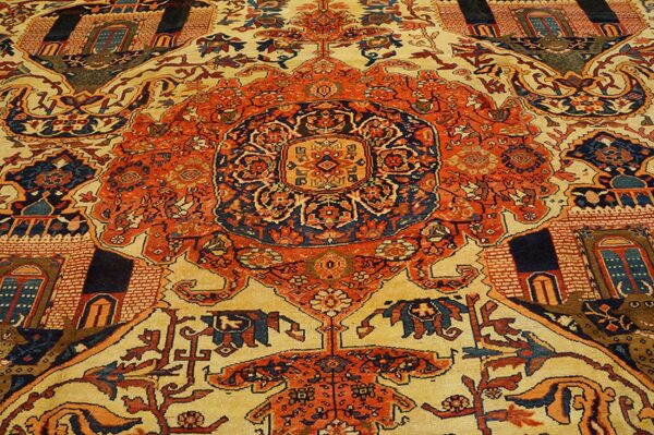 Close-up of a richly patterned rug featuring central medallions and architectural motifs in orange, blue, and cream, by rugs on net