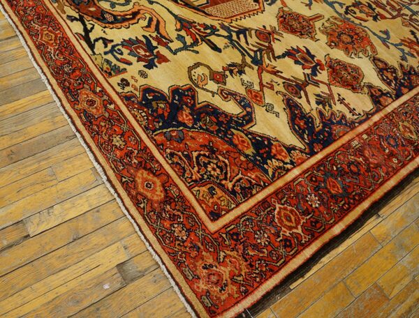 Close-up of an antique persian rug with red and navy accents on a cream field, resting on aged wooden floors, by rugs on net