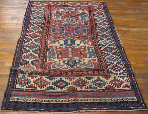 Geometric runner rug with red and blue motifs on a light ground by rugs on net