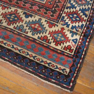 Close-up of geometric patterns in red, blue, and cream on the Oriental Rug by Rugs On Net. by Rugs On Net