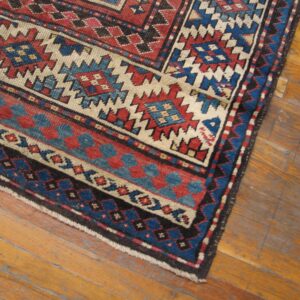 Close-up corner of a tribal rug with red, blue, and cream geometric patterns by Rugs On Net. by Rugs On Net