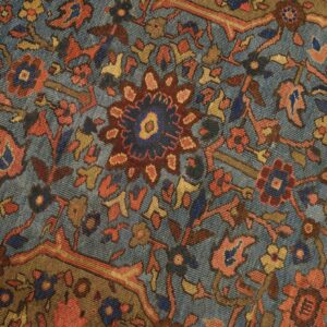 Close-up of a blue field rug with intricate floral patterns in red, gold, and brown by Rugs On Net. by Rugs On Net
