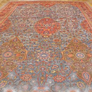 Close-up view of an antique Persian rug with intricate blue, red, and gold patterns by Rugs On Net