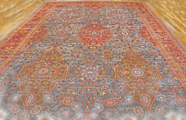 Close-up view of an antique persian rug with intricate blue, red, and gold patterns by rugs on net