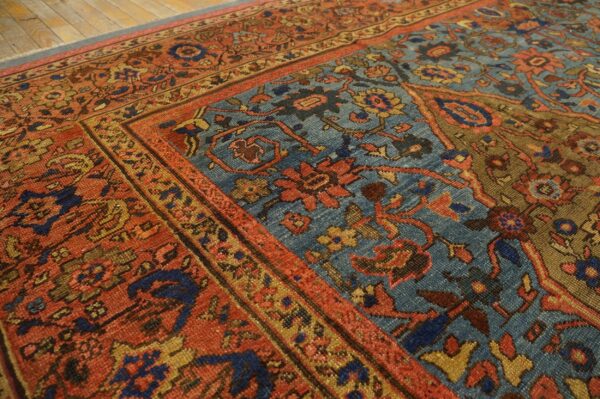 Close-up of an antique rug with rich red and blue tones, showing detailed floral motifs by rugs on net. By rugs on net