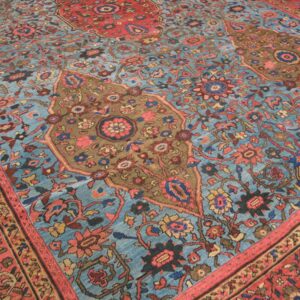 Close-up of a blue and red floral antique rug by Rugs On Net