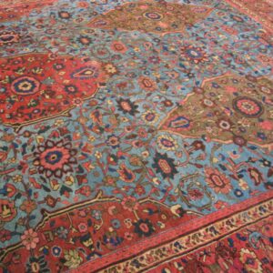 Close-up of a blue and red patterned rug, by Rugs On Net