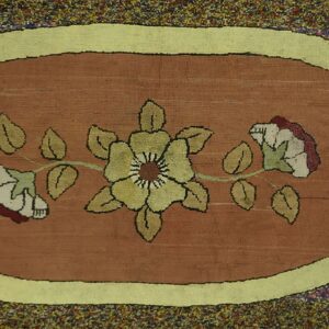 Close-up of an Oval Floral Hooked Rug featuring a central yellow flower design on a rust-colored ground, framed by a lime green border by Rugs On Net