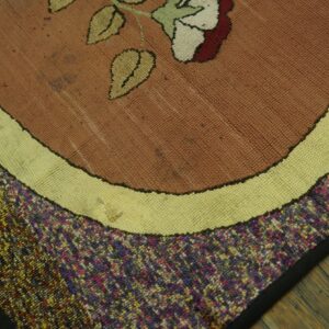 Close-up of a floral hooked rug with brown, cream, and multicolored borders by Rugs On Net. by Rugs On Net