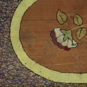 Close-up of a hooked rug featuring a floral design with brown, yellow, and multicolored borders, by Rugs On Net. by Rugs On Net