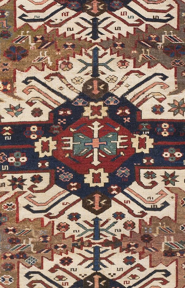 Close-up of geometric patterns and rich colors on an antique rug by rugs on net. By rugs on net