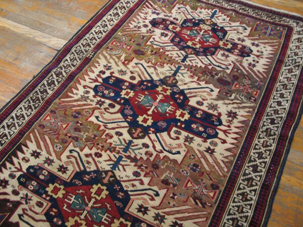 Close-up view of a tribal rug with geometric medallions on a light field by rugs on net