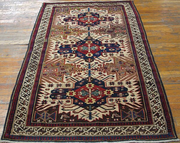 A long, narrow tribal rug with geometric patterns in red, blue, and cream colors, by rugs on net. By rugs on net