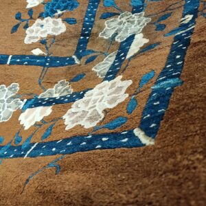 Close-up of a brown rug with blue and white floral accents, by Rugs On Net
