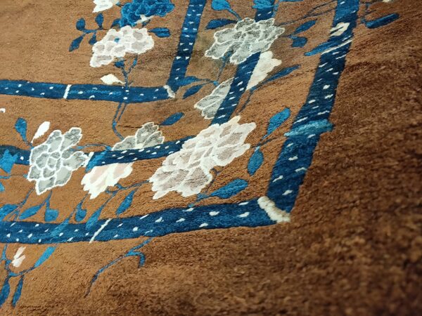 Close-up of a brown rug with blue and white floral accents, by rugs on net
