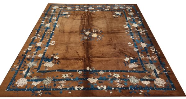Brown rug with blue and white floral border, oriental design by rugs on net