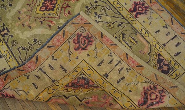 Close-up showing the backing of a green and pink patterned rug, by rugs on net. By rugs on net