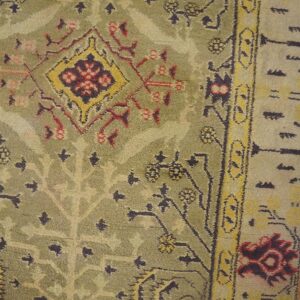 Close-up of an antique green and yellow patterned rug by Rugs On Net. by Rugs On Net