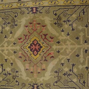Close-up of a vintage green and cream rug with geometric patterns by Rugs On Net. by Rugs On Net