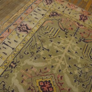 Close-up of an olive green and beige patterned rug on a wooden floor by Rugs On Net