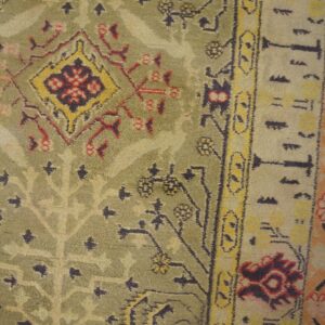 Close-up of a green and red patterned rug detail by Rugs On Net