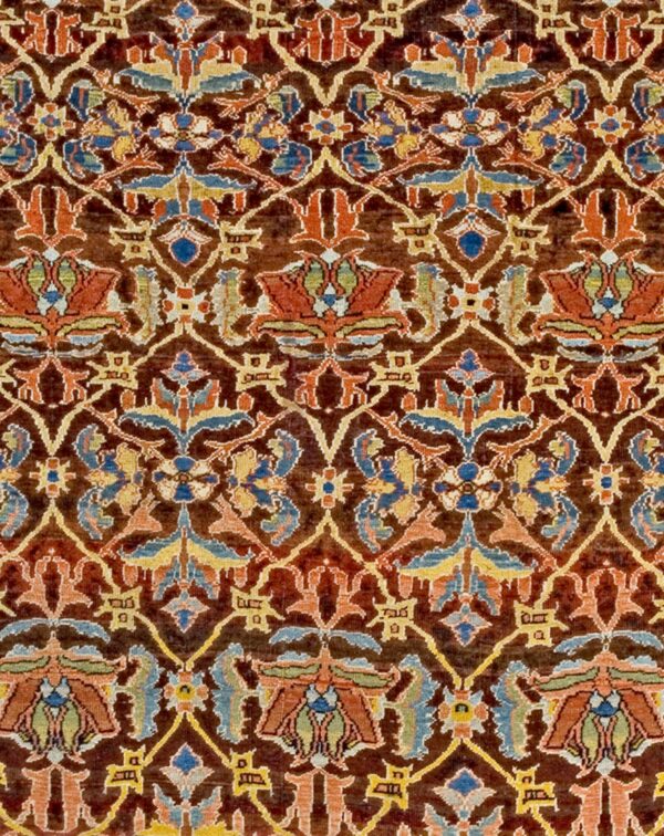 Close-up detail of a richly colored, dark brown antique rug with intricate floral and vine motifs in reds, blues, and yellows, by rugs on net