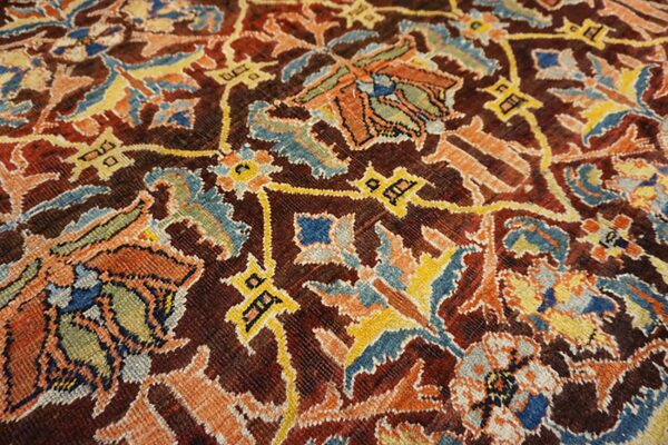 Close-up of the intricate floral and geometric patterns on the dark red persian rug by rugs on net. By rugs on net