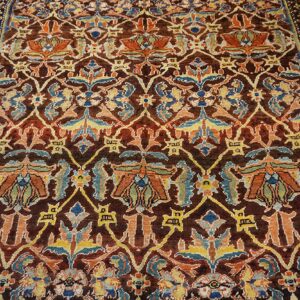 Close-up of an antique rug with rich brown, orange, and blue floral patterns by Rugs On Net