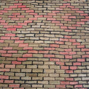 Close-up of a rug with a brick pattern in red and tan shades, by Rugs On Net