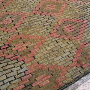 Close-up of a textured rug with a staggered brick pattern in shades of pink, beige, and brown, by Rugs On Net