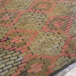 Close-up of a textured rug with a brick-like pattern in pink, tan, and brown tones by Rugs On Net. by Rugs On Net