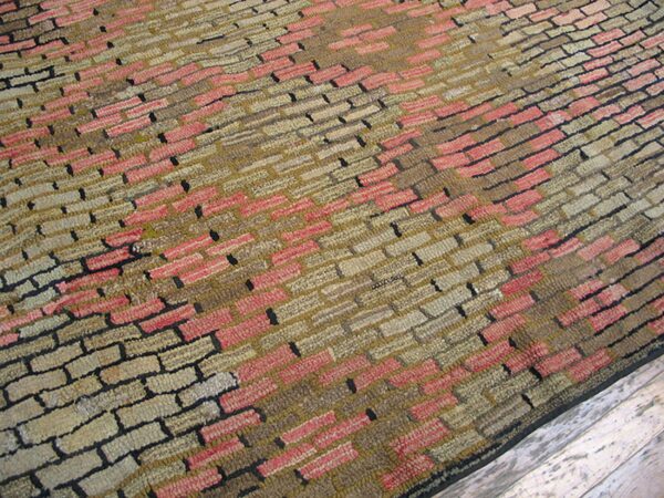 Close-up of a textured rug with a brick-like pattern in pink, tan, and brown tones by rugs on net. By rugs on net