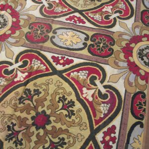 Close-up of a richly patterned rug featuring red, gold, and black medallions by Rugs On Net. by Rugs On Net
