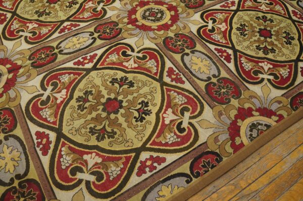 Close-up of a richly patterned tapestry rug with red, gold, and black motifs, by rugs on net. By rugs on net
