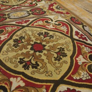Close-up of a colorful Aubusson style rug with intricate medallions and floral motifs on a light wood floor by Rugs On Net